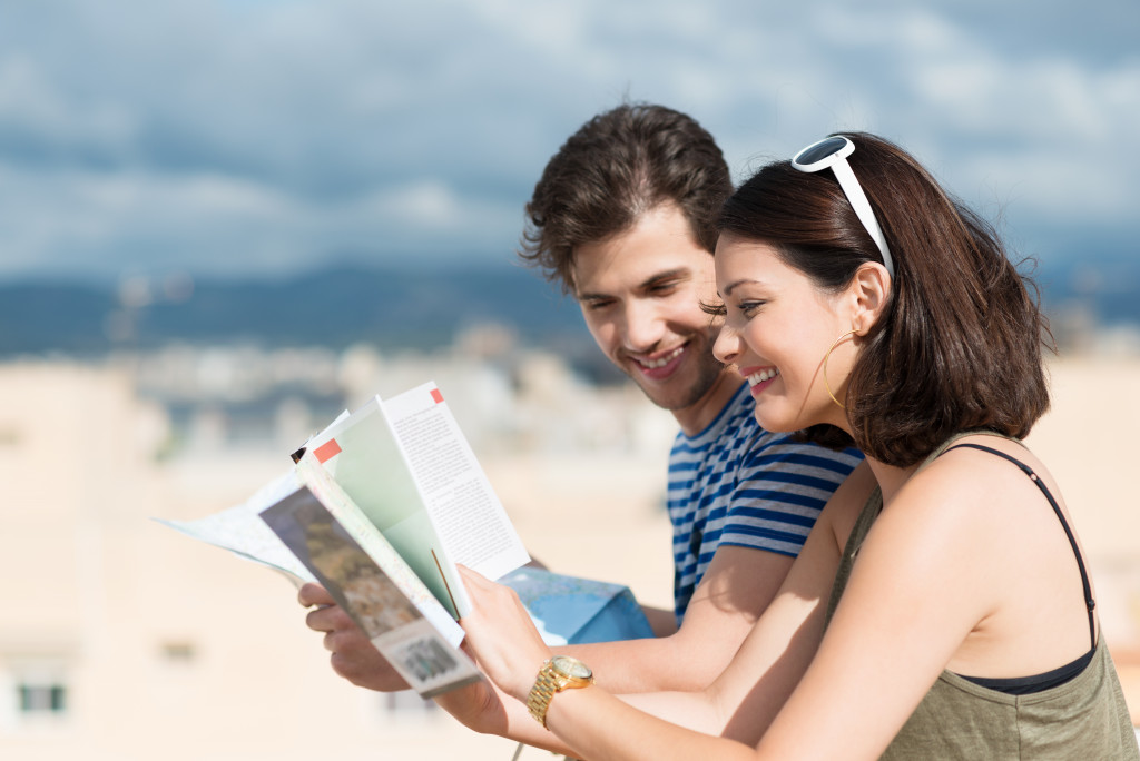 couple reading a book in the beachside