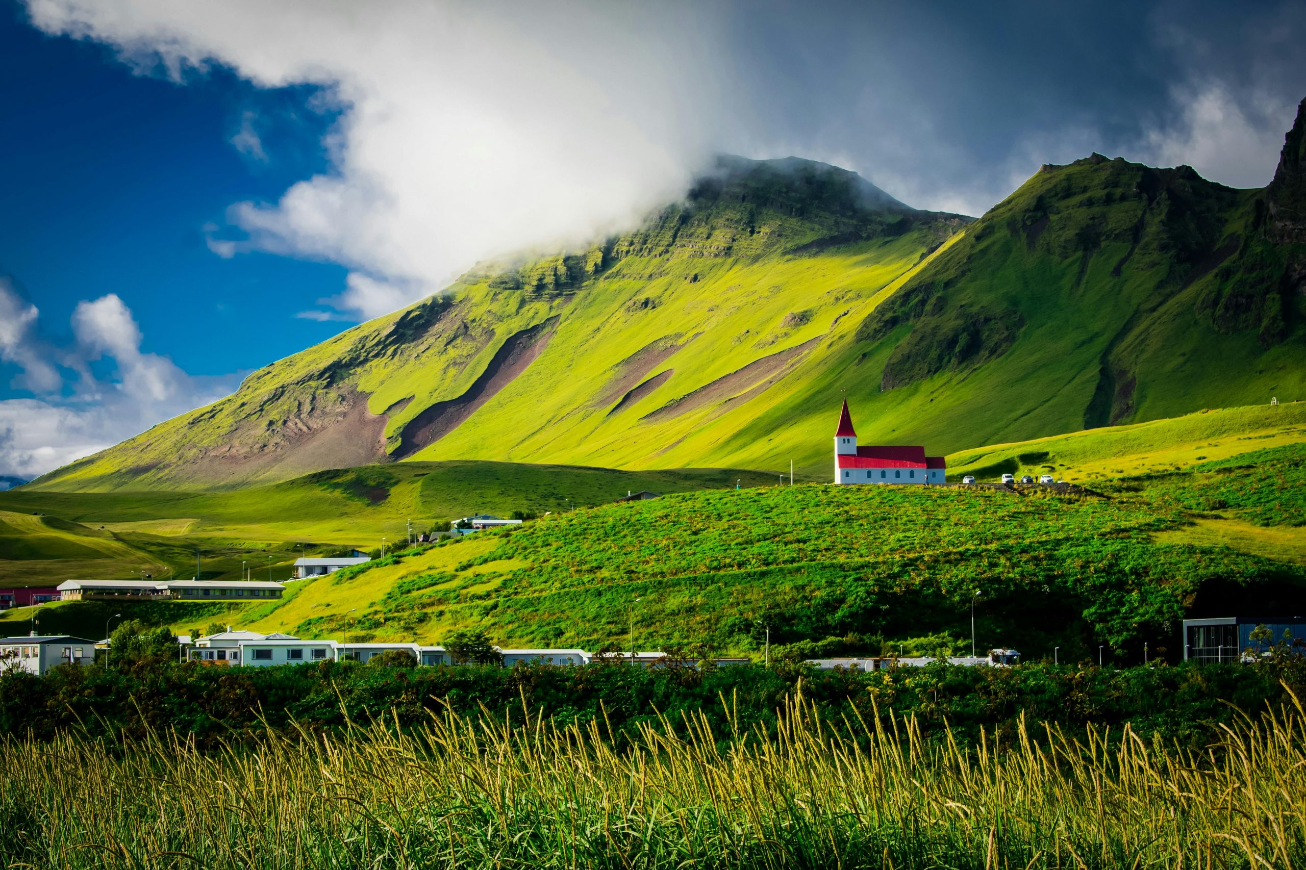 lush green mountains under clear skies in Vik, Iceland
