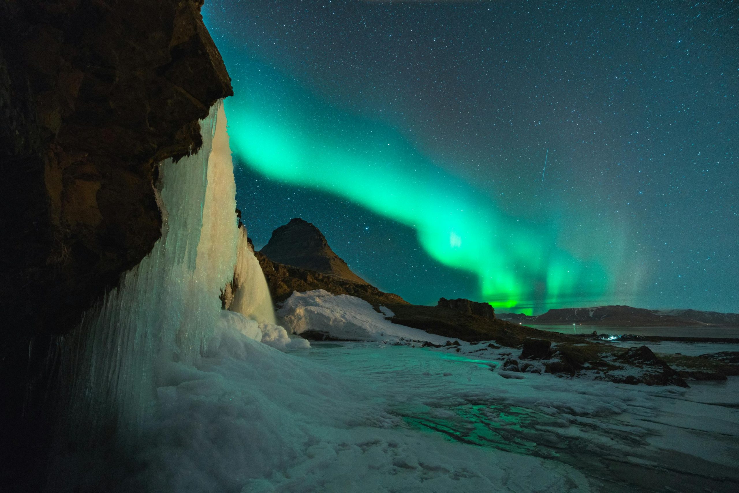 Northern lights glowing over a snowy landscape in Iceland